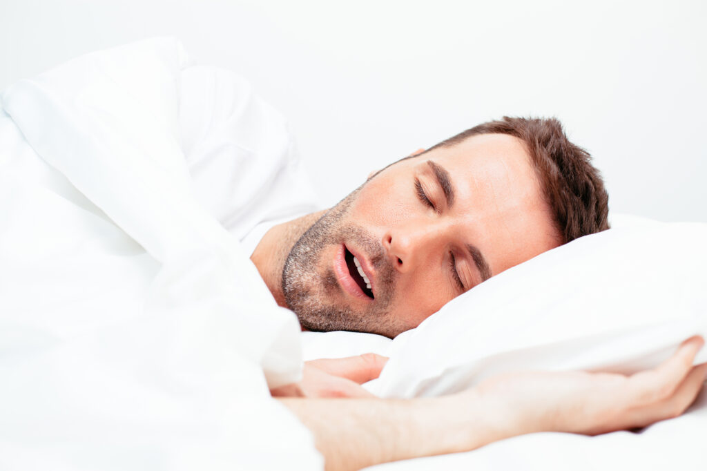 man snoring in bed