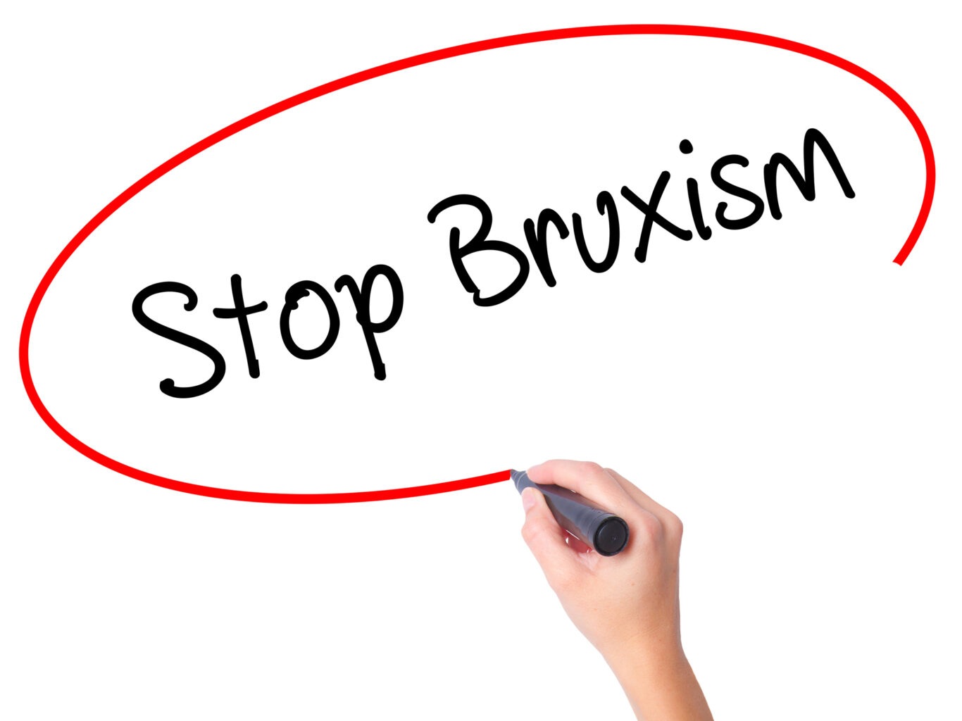 woman writing "stop bruxism"