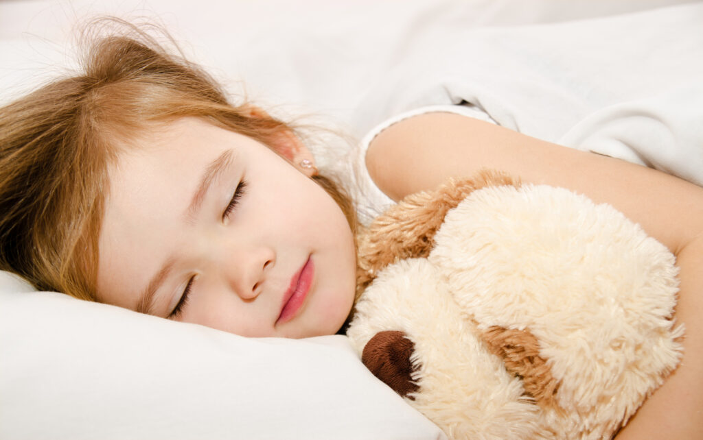 little girl asleep with stuffed puppy