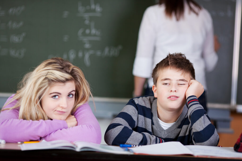 sleepy teenagers in classroom