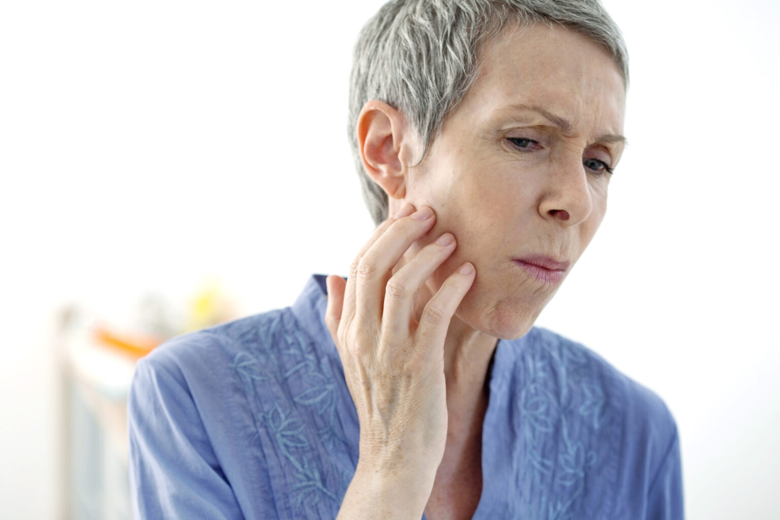 older woman with jaw pain