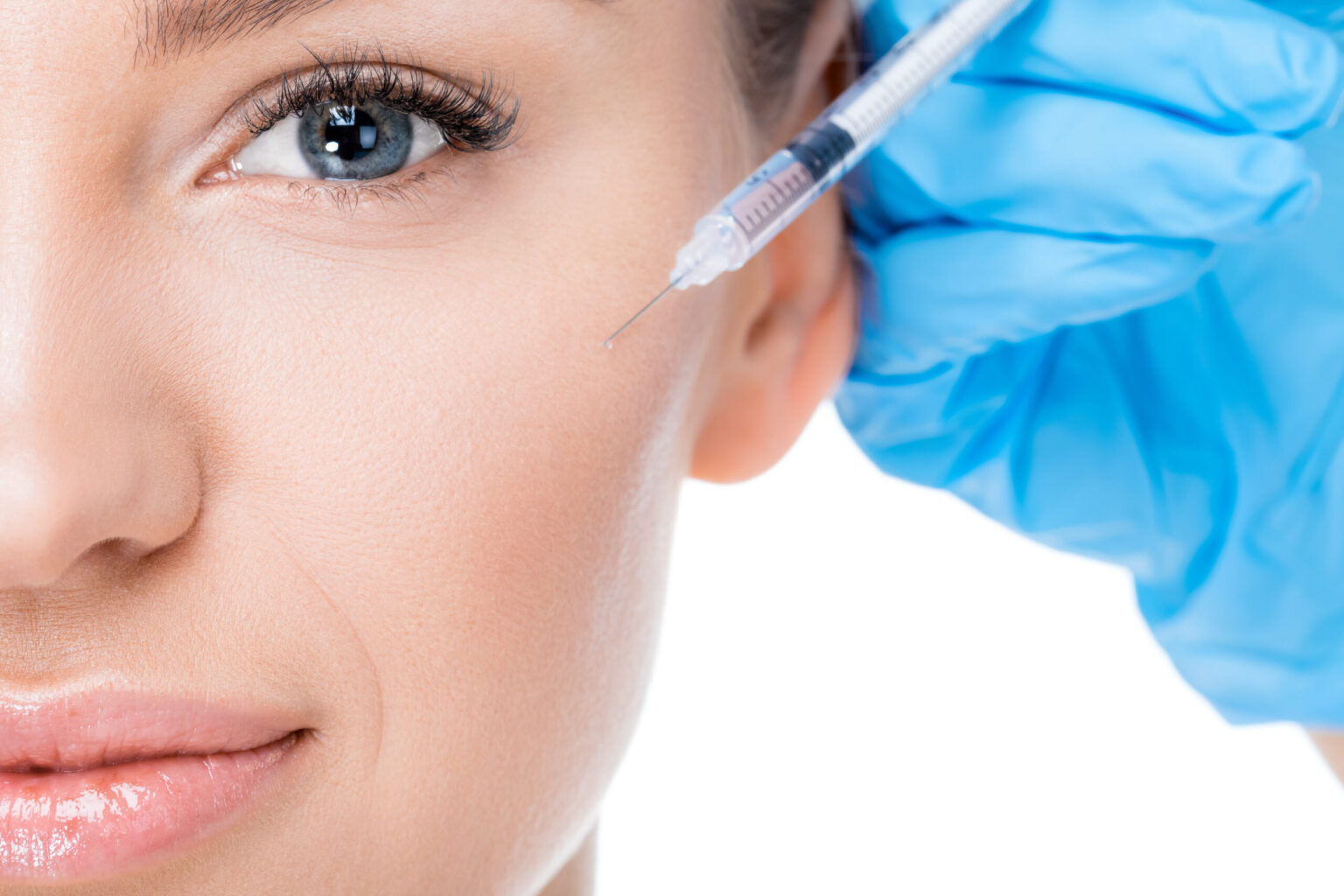 woman receiving BOTOX injection by doctor with blue glove