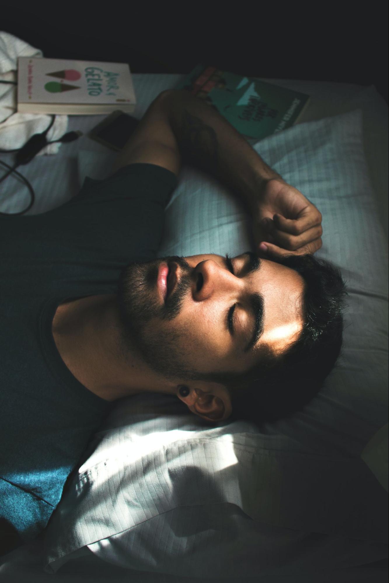 Young man snoring while sleeping on his back