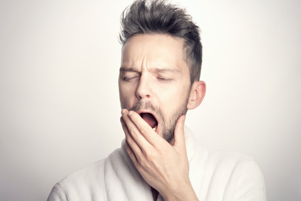 Man yawns due to sleep apnea and snoring